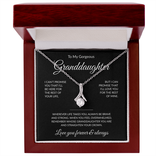 Delicate necklace with heartfelt message to granddaughter, styled on a vanilty in warm store tones. 